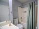 Functional bathroom featuring a shower-tub combo, single sink vanity, and easy-to-clean surfaces at 4184 Red Laurel Way, Snellville, GA 30039
