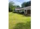 Home with carport, lush landscaping, and an expansive green lawn at 4184 Red Laurel Way, Snellville, GA 30039