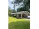 Single-story home with a covered carport, neat landscaping, and a well-maintained lawn and mature trees at 4184 Red Laurel Way, Snellville, GA 30039
