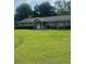 Charming single-story home featuring a well-manicured lawn, complemented by mature trees and neatly trimmed hedges at 4184 Red Laurel Way, Snellville, GA 30039