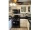 Functional kitchen equipped with stainless steel appliances, classic white cabinetry, and dark countertops providing an aesthetic design at 4184 Red Laurel Way, Snellville, GA 30039