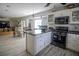 Modern kitchen with a center island, stainless steel appliances, and an adjacent dining area at 4184 Red Laurel Way, Snellville, GA 30039