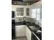 Charming kitchen featuring bright white cabinets, dark countertops, and modern appliances creating an inviting cooking space at 4184 Red Laurel Way, Snellville, GA 30039