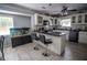 Bright eat-in kitchen with white cabinets, gray appliances, breakfast bar and modern lighting fixtures at 4184 Red Laurel Way, Snellville, GA 30039