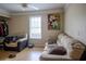 Cozy living room featuring a comfortable sofa, chair, and a bright window with natural light at 4184 Red Laurel Way, Snellville, GA 30039