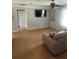 Living room featuring a mounted TV, ceiling fan, natural light, and a comfortable sofa at 4184 Red Laurel Way, Snellville, GA 30039
