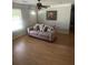 Bright living room with ceiling fan, neutral colored walls, and a comfortable couch at 4184 Red Laurel Way, Snellville, GA 30039