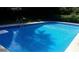 A refreshing in-ground pool featuring crystal clear water, surrounded by well-maintained landscaping for outdoor enjoyment at 4184 Red Laurel Way, Snellville, GA 30039