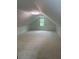 Bright attic space with neutral carpet, light fixture, and window at 4307 Cedar Wood Sw Dr, Lilburn, GA 30047