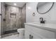 Modern bathroom features a walk-in shower, black hardware, and a marble-look vanity at 4307 Cedar Wood Sw Dr, Lilburn, GA 30047