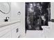 Elegant bathroom with dual sinks, a modern shower, and designer marble finishes at 4307 Cedar Wood Sw Dr, Lilburn, GA 30047