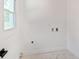 Clean, white laundry room with tile floors and utility connections at 4307 Cedar Wood Sw Dr, Lilburn, GA 30047