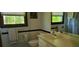 Well-lit bathroom featuring a neutral-toned vanity, a bathtub with shower, and a large mirror at 4662 Burns Rd, Lilburn, GA 30047