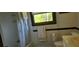 Bathroom featuring a bathtub with shower, window with blinds, and a neutral-toned vanity at 4662 Burns Rd, Lilburn, GA 30047