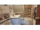 Bathroom featuring a vanity, toilet, and a tiled shower with a sliding glass door at 4662 Burns Rd, Lilburn, GA 30047