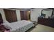 Comfortable bedroom with a plush bed, wooden dresser with mirror, and closet storage at 4662 Burns Rd, Lilburn, GA 30047
