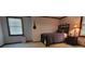 Bedroom featuring a twin bed, side table, and large window with natural light at 4662 Burns Rd, Lilburn, GA 30047