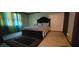 Bright bedroom with large window, dark wood bed frame, and a patterned rug on carpeted floor at 4662 Burns Rd, Lilburn, GA 30047