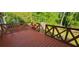 A spacious wood deck with red railings provides an outdoor living space at 4662 Burns Rd, Lilburn, GA 30047