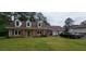 Charming brick home with a well-manicured lawn, dormer windows, and a two-car garage at 4662 Burns Rd, Lilburn, GA 30047