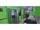 Bright kitchen featuring green cabinetry, a stainless-steel refrigerator, and a mosaic tile backsplash at 4662 Burns Rd, Lilburn, GA 30047