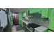 Bright kitchen featuring green cabinetry, stainless appliances, and a unique mosaic backsplash at 4662 Burns Rd, Lilburn, GA 30047