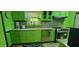 Modern kitchen with stainless steel appliances and bright green cabinets at 4662 Burns Rd, Lilburn, GA 30047