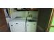 Bright laundry room featuring a white washer and dryer unit with wooden door at 4662 Burns Rd, Lilburn, GA 30047