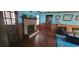 Living room boasts wood paneled walls, a fireplace, and dark wooden door with sidelight windows at 4662 Burns Rd, Lilburn, GA 30047