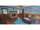Inviting living room with brick fireplace, wood paneling, and hardwood floors at 4662 Burns Rd, Lilburn, GA 30047