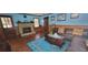 Inviting living room with brick fireplace, wood paneling, and hardwood floors at 4662 Burns Rd, Lilburn, GA 30047