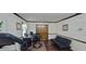 Functional office space with a black futon, desk setup, and a decorative rug on wood-look floors at 4662 Burns Rd, Lilburn, GA 30047