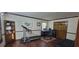 Well-lit home office featuring a desk, treadmill, wooden accents, and decorative rug on wood-look floors at 4662 Burns Rd, Lilburn, GA 30047