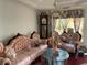 Features ornate pink sofas, a vintage clock, and unique decor, creating a distinctive and furnished living space at 5001 Panola Mill Dr, Lithonia, GA 30038