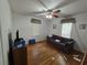 Bedroom with hardwood floors, ceiling fan, and natural light filtering through the windows at 502 S Evelyn Nw Pl, Atlanta, GA 30318