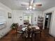 Bright dining room with hardwood floors, ceiling fan and a view into the living room beyond at 502 S Evelyn Nw Pl, Atlanta, GA 30318