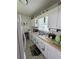 Compact kitchen with white cabinets, laminate countertops and a dual stainless steel sink at 502 S Evelyn Nw Pl, Atlanta, GA 30318