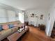 Bright living room with hardwood floors, a decorative fireplace, and a comfortable couch at 502 S Evelyn Nw Pl, Atlanta, GA 30318