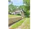 Side view of the house showing the yard and a concrete barrier at 502 S Evelyn Nw Pl, Atlanta, GA 30318