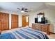 Bright bedroom features wooden closet doors, a ceiling fan, and an ensuite bathroom at 2435 Farmer Road, Conyers, GA 30012