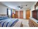 Spacious bedroom boasts a ceiling fan, hardwood floors, and ample storage space provided by large closets at 2435 Farmer Road, Conyers, GA 30012