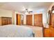 Spacious bedroom offers ample storage with wooden closets and dresser, plus an ensuite bathroom at 2435 Farmer Road, Conyers, GA 30012