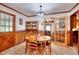 Cozy dining room boasts hardwood floors, wood trim, updated lighting, and an adjacent built-in china cabinet at 2435 Farmer Road, Conyers, GA 30012