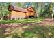 Exterior view of the wood-sided house showing a well-maintained lawn and landscaping at 2435 Farmer Road, Conyers, GA 30012