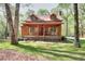 Charming cabin home featuring dormer windows and a welcoming front porch with seating at 2435 Farmer Road, Conyers, GA 30012