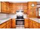 Traditional kitchen features wood cabinets, white tile backsplash, stainless steel range, and stone countertops at 2435 Farmer Road, Conyers, GA 30012