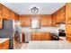Well-maintained kitchen featuring stainless steel appliances, granite counters, and wooden cabinets at 2435 Farmer Road, Conyers, GA 30012
