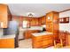 Well-maintained kitchen featuring stainless steel appliances, granite counters, and wooden cabinets at 2435 Farmer Road, Conyers, GA 30012