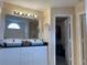 Modern bathroom with dual sinks, granite countertops, and ample lighting, providing a luxurious feel at 1421 Isleworth Cir, College Park, GA 30349