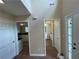 Hallway featuring wood floors and multiple doorways leading to various rooms within the home at 1421 Isleworth Cir, College Park, GA 30349